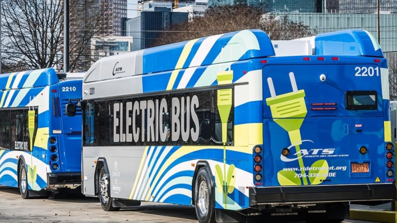 electric buses charging on a city street