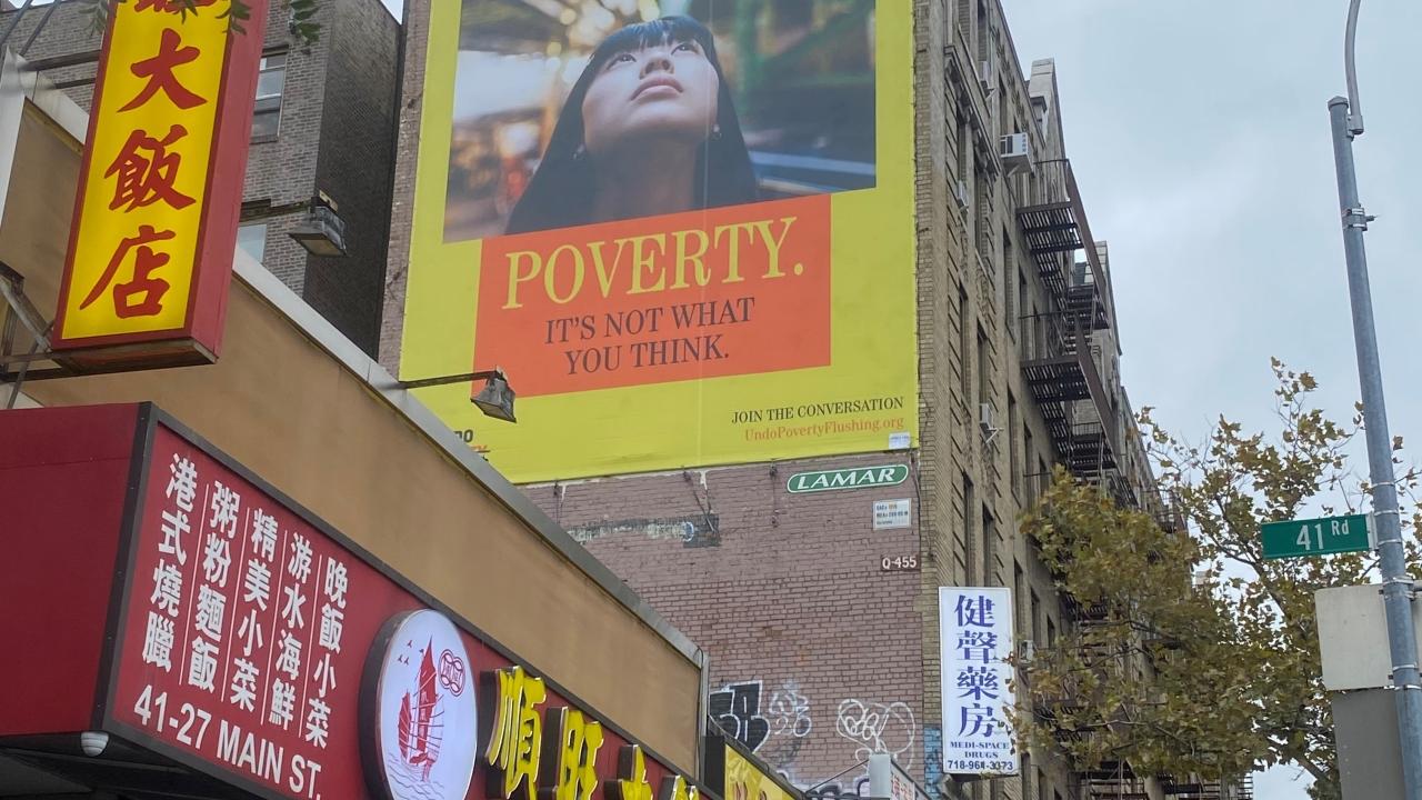 Building with a billboard that reads: Poverty. It's not what you think.