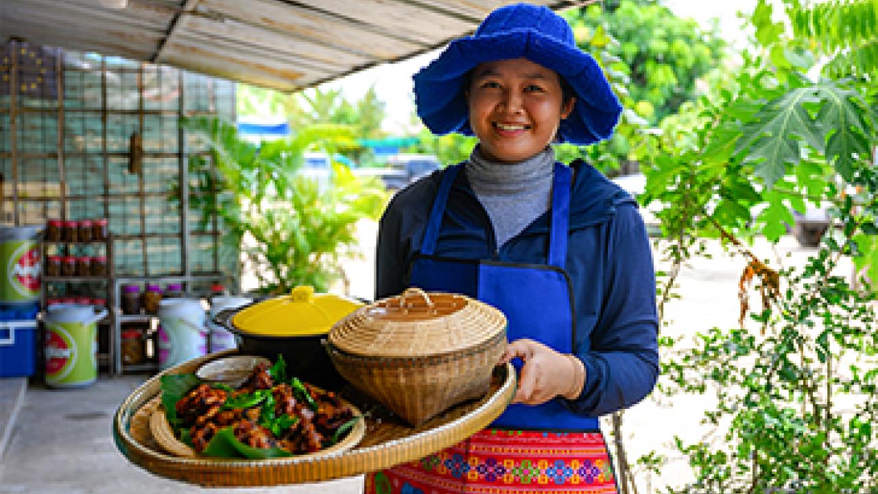 Woman holding tray of food 