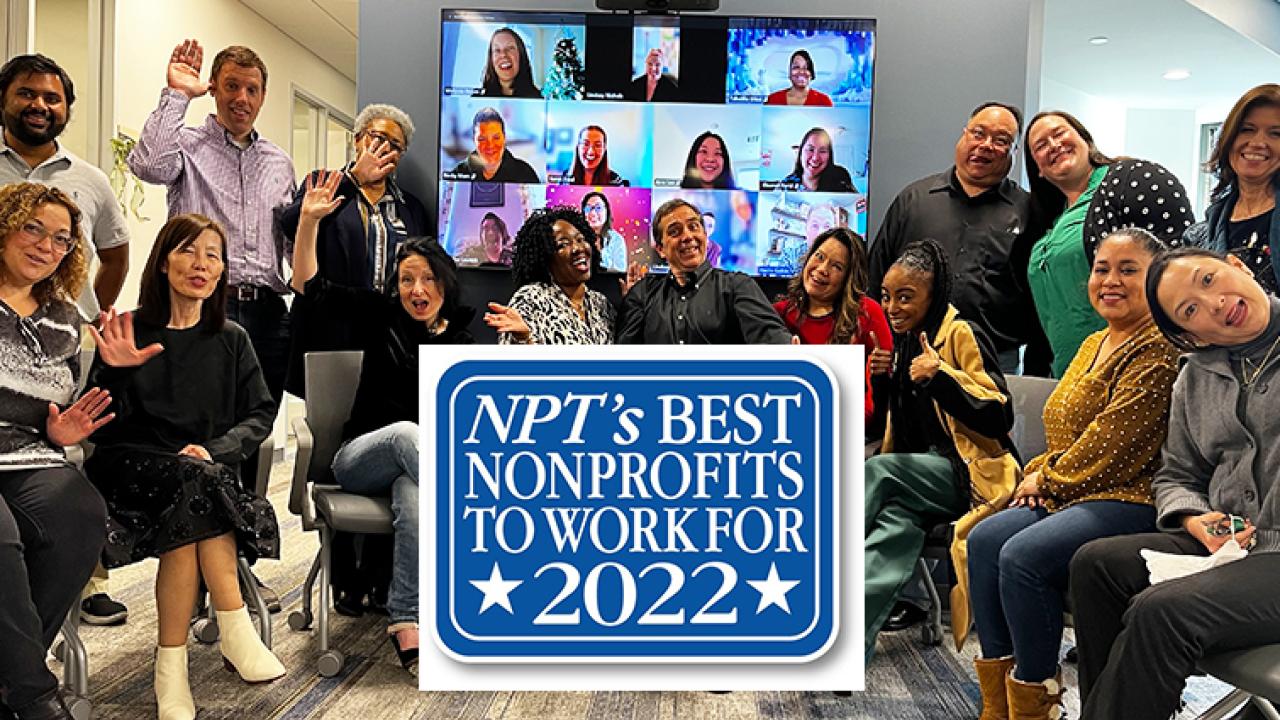 America's Charities Staff - some standing, some sitting, and some whose faces are visible on computer monitors - smile and wave at the camera