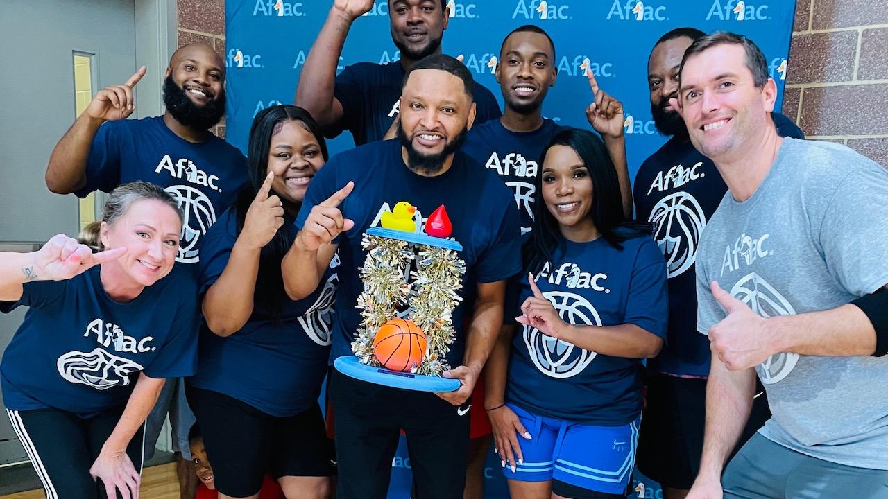 The winning team and top fundraisers — Aflac Employee Team:  Front row: Erica Cavanagh, Melissa Davis, Kendall Saxon, Veronica Goodwin, with Bob Ruff. Back row: Brandon Smalls, Quan Prowell, Refeno King, Jordan Vernon.