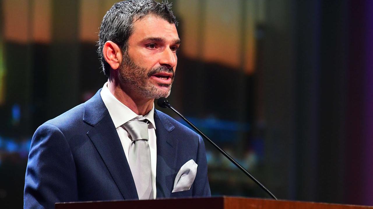 A person speaking into a microphone 