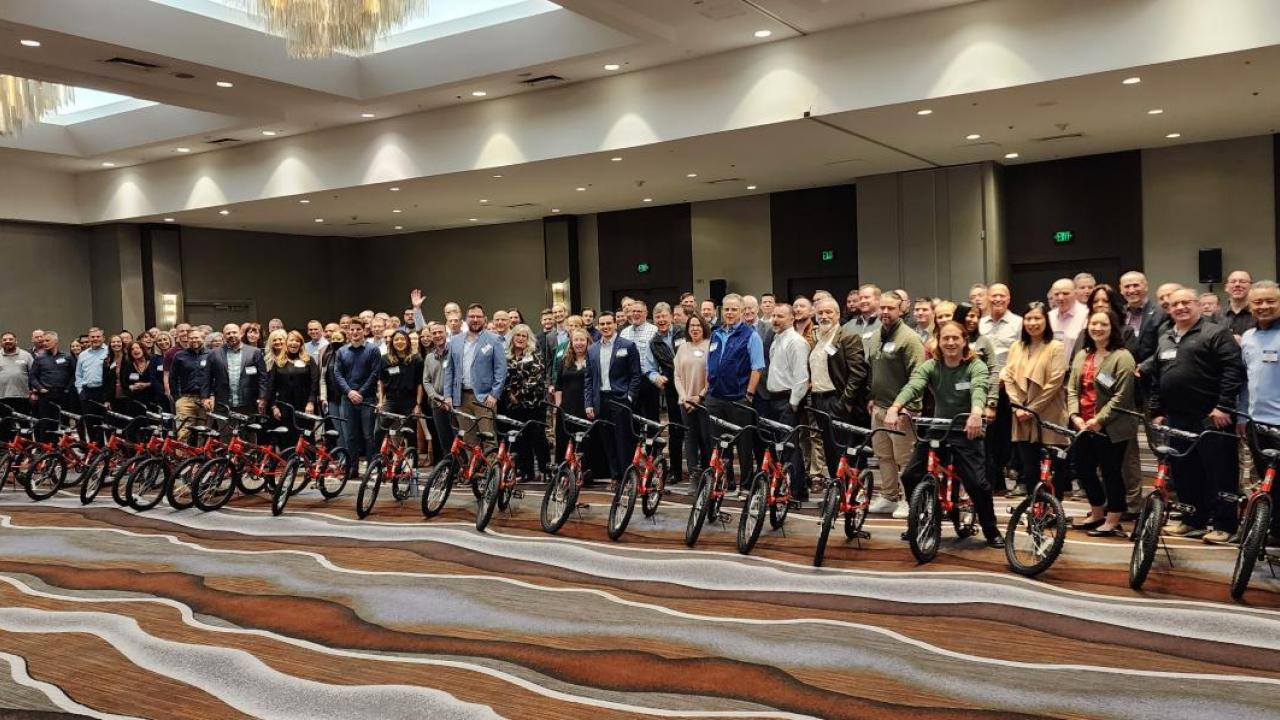 Arrow electronics employees pose with newly built bikes.