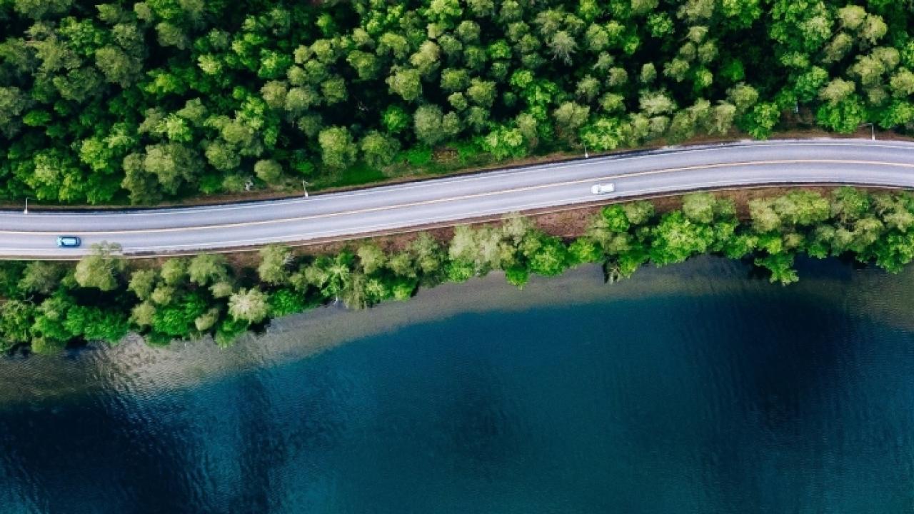 overhead image of cars driving along a windy road 