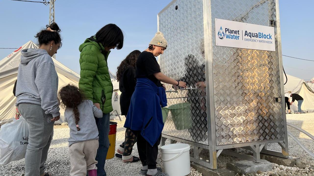 Clean, safe water being accessed at a relocation camp for earthquake survivors