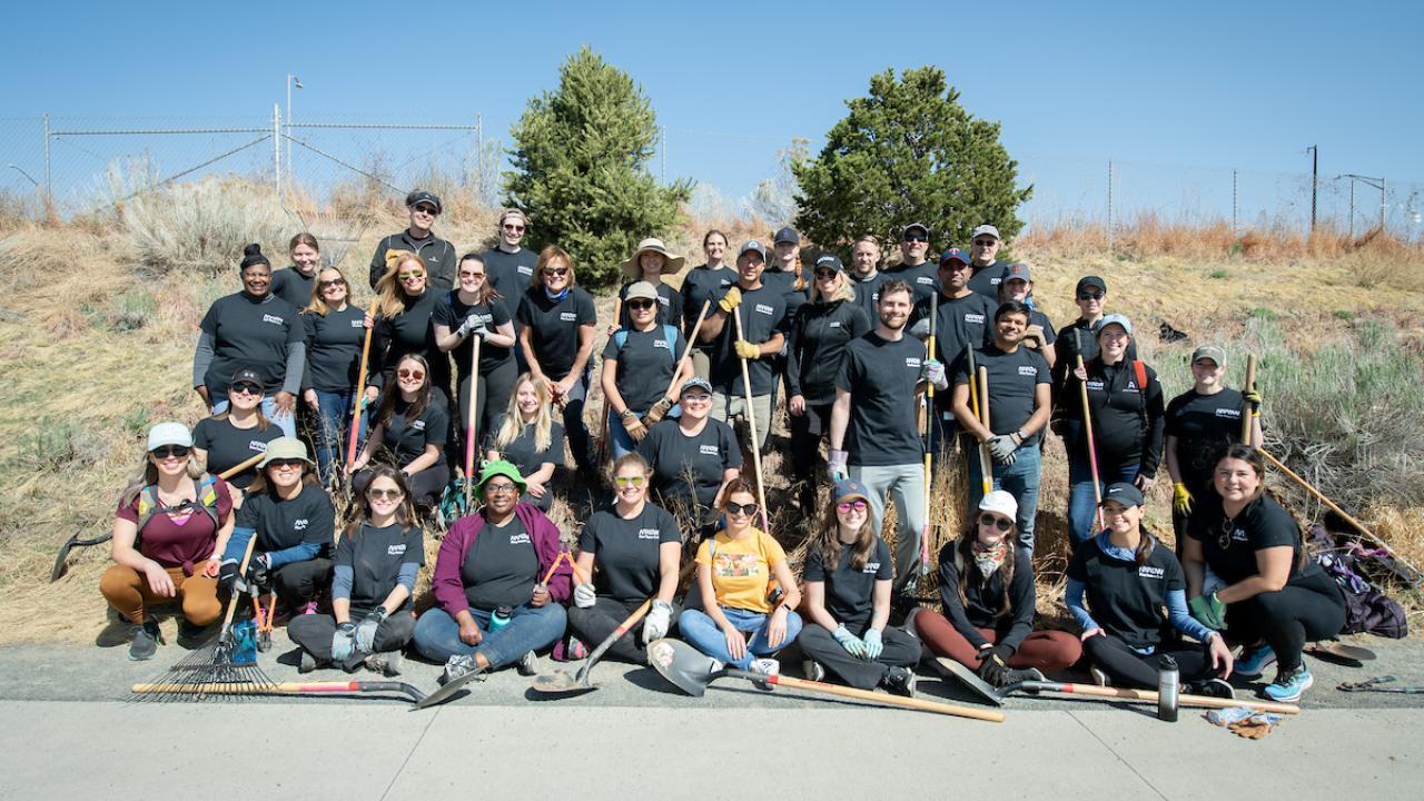 Arrow employees pose for a group photo while planting trees on Earth Day 
