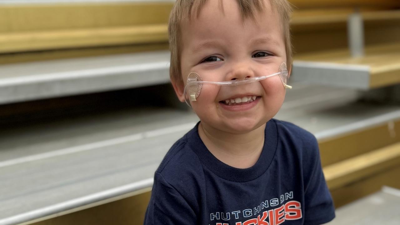 Toddler Cameron Olson shown with breathing apparatus.