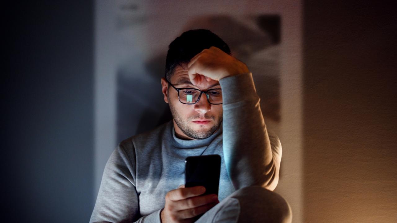 Person looking at smartphone in the dark