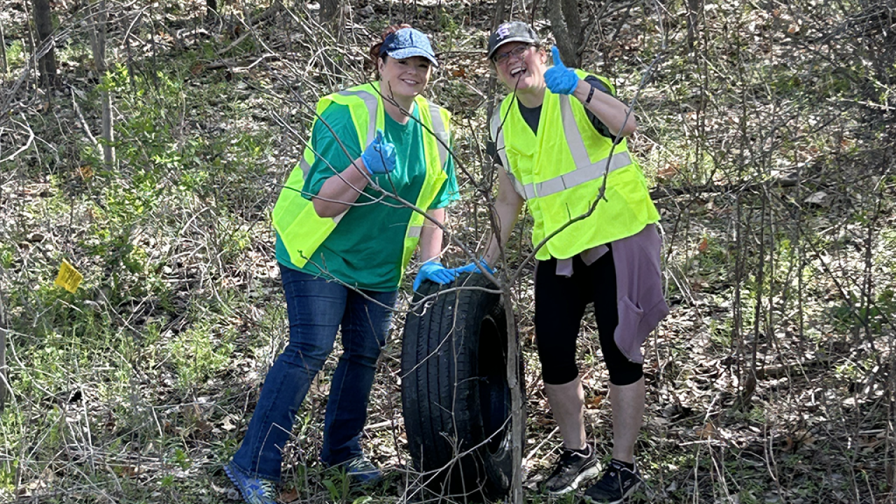 Two people in safety vests giving thumbs up