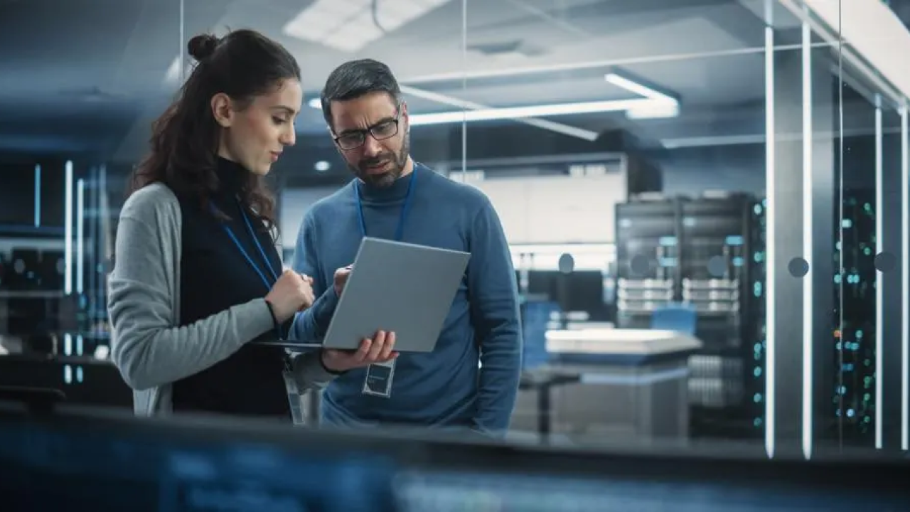 Two people looking at a laptop