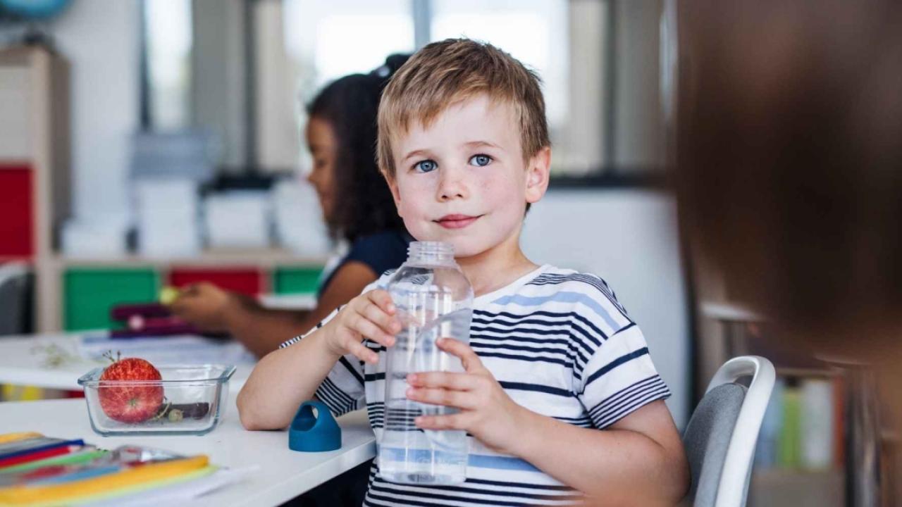 Delos:  Boy with water bottle. 