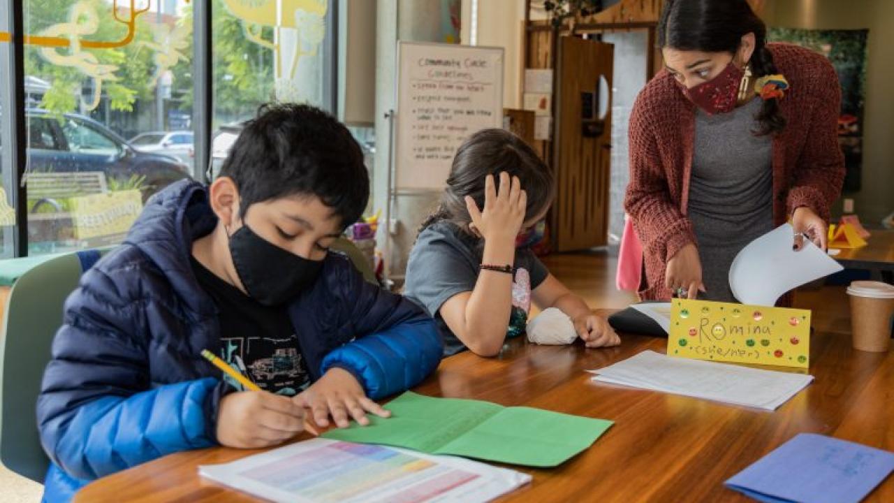 An instructor providing guidance to students at 826 Valencia. Photo by Malcolm Eaton