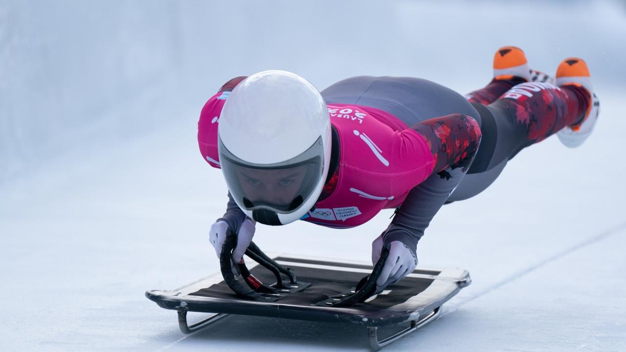 Olympic athlete jumping onto a sled