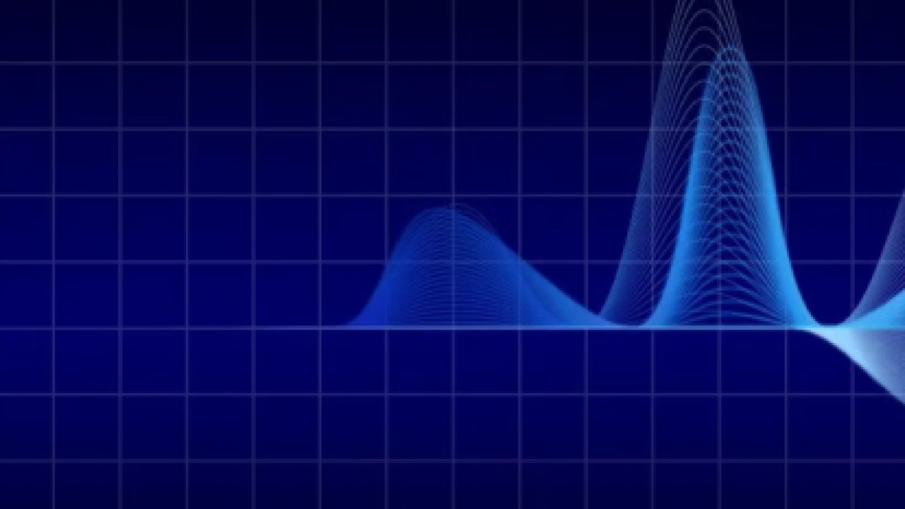 On a dark blue background, mid way white sound wave type image appears and gets bolder further to the right.