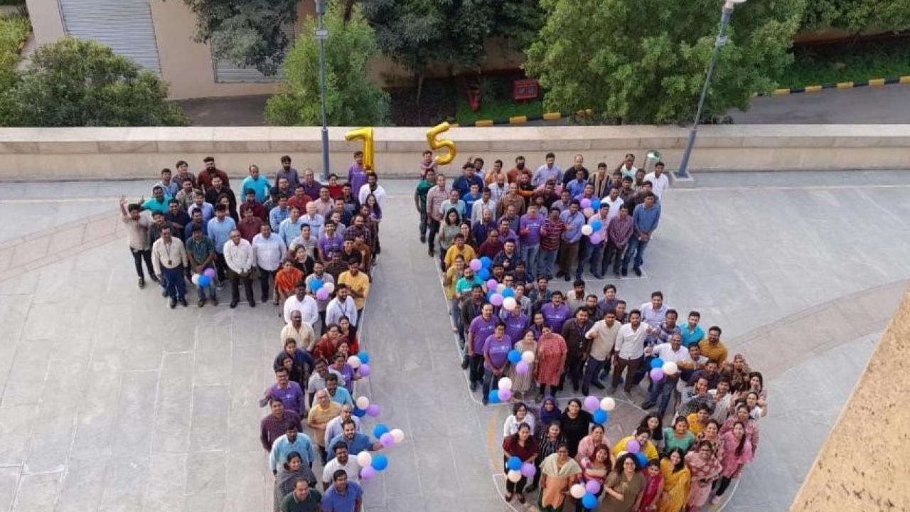 people gathered together to spell out "75"