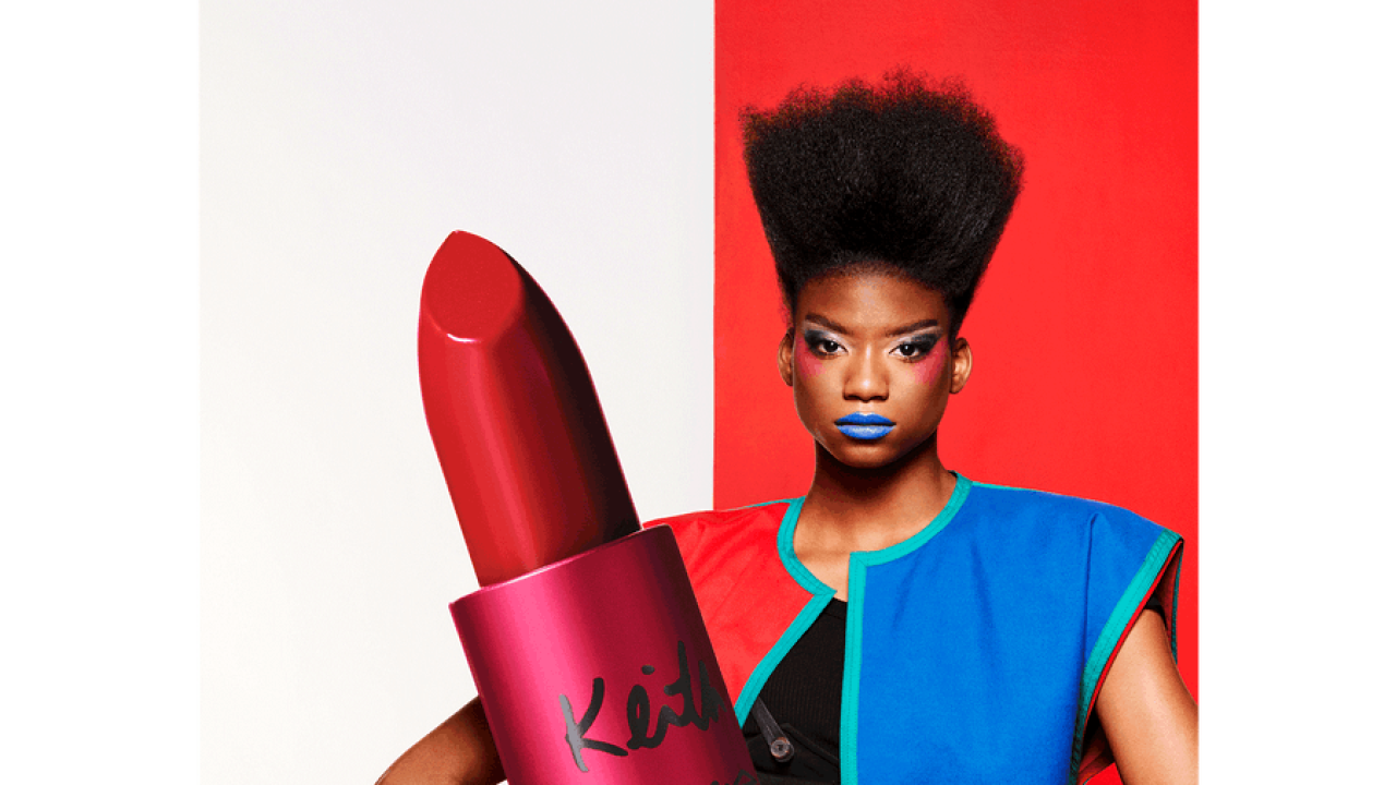 Person holding an oversized lipstick for display