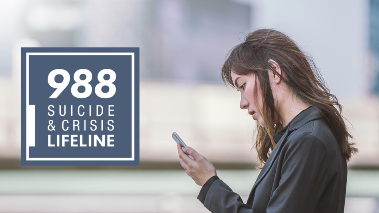 a person looking at a phone. The 988 suicide & crisis lifeline logo on the left