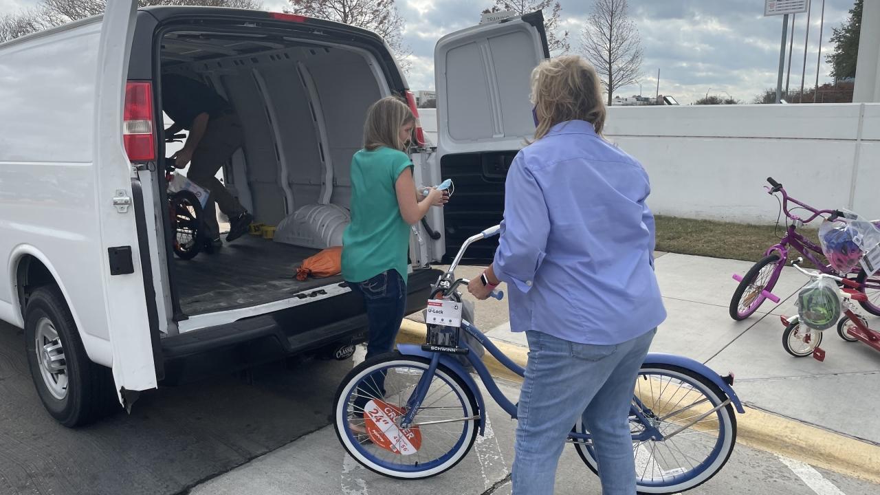 woman loading bike into van