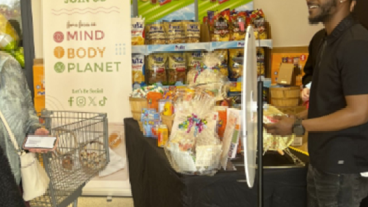 A person standing at a store with a booth