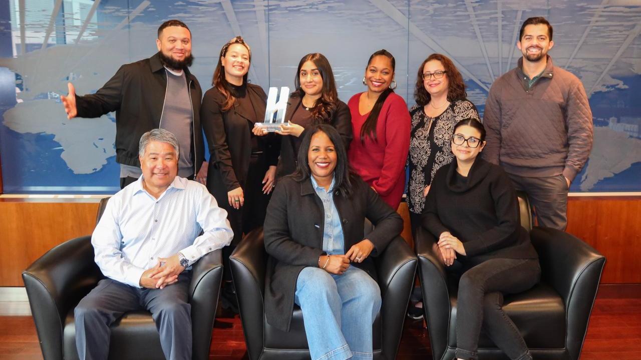 AEG's Talent Acquisition Team posed with Handshake's Early Talent Award. 