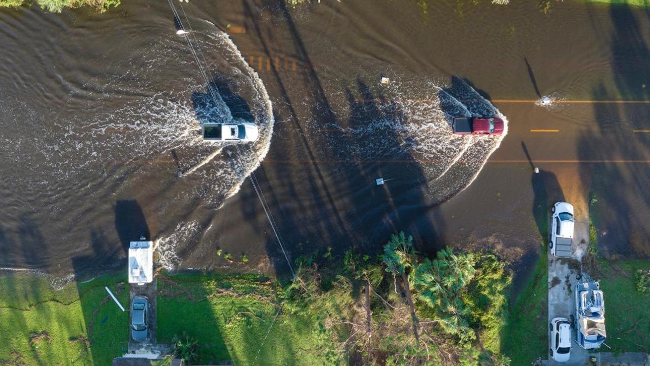 Aerial view of cars driving through a flooded street