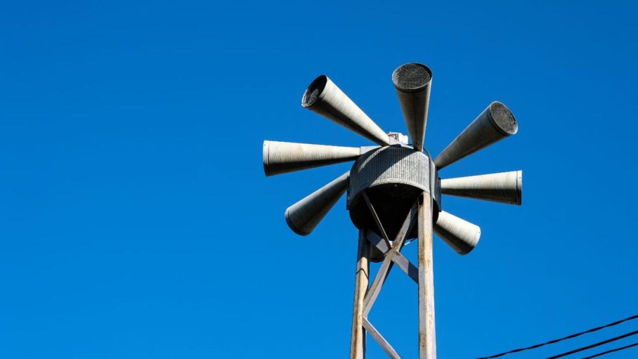 Civil defense sirens under a blue sky