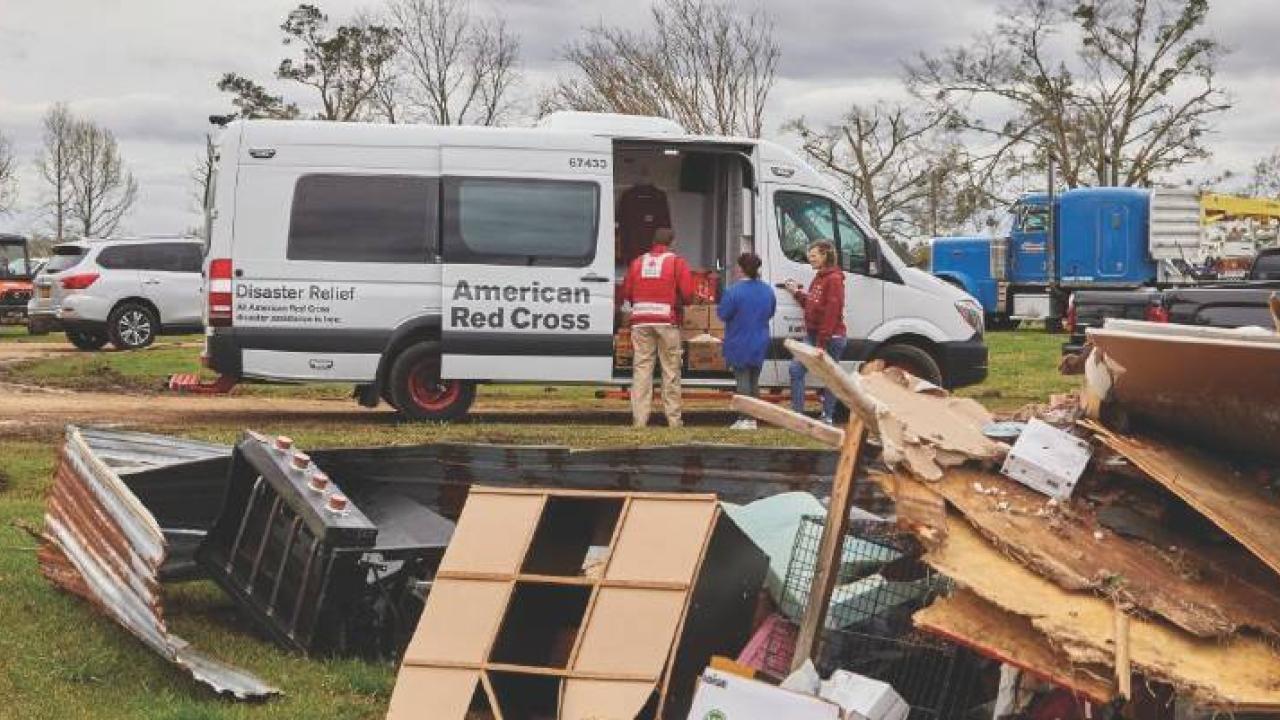 an american red cross van , a pile of debris in front