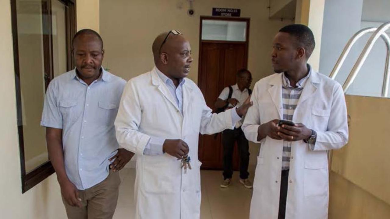 Doctor's shown in Africa consulting with a patient.