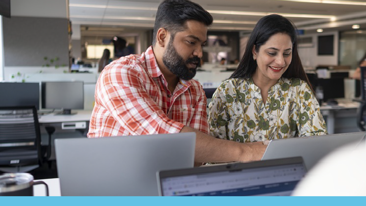 Two people looking at a computer together