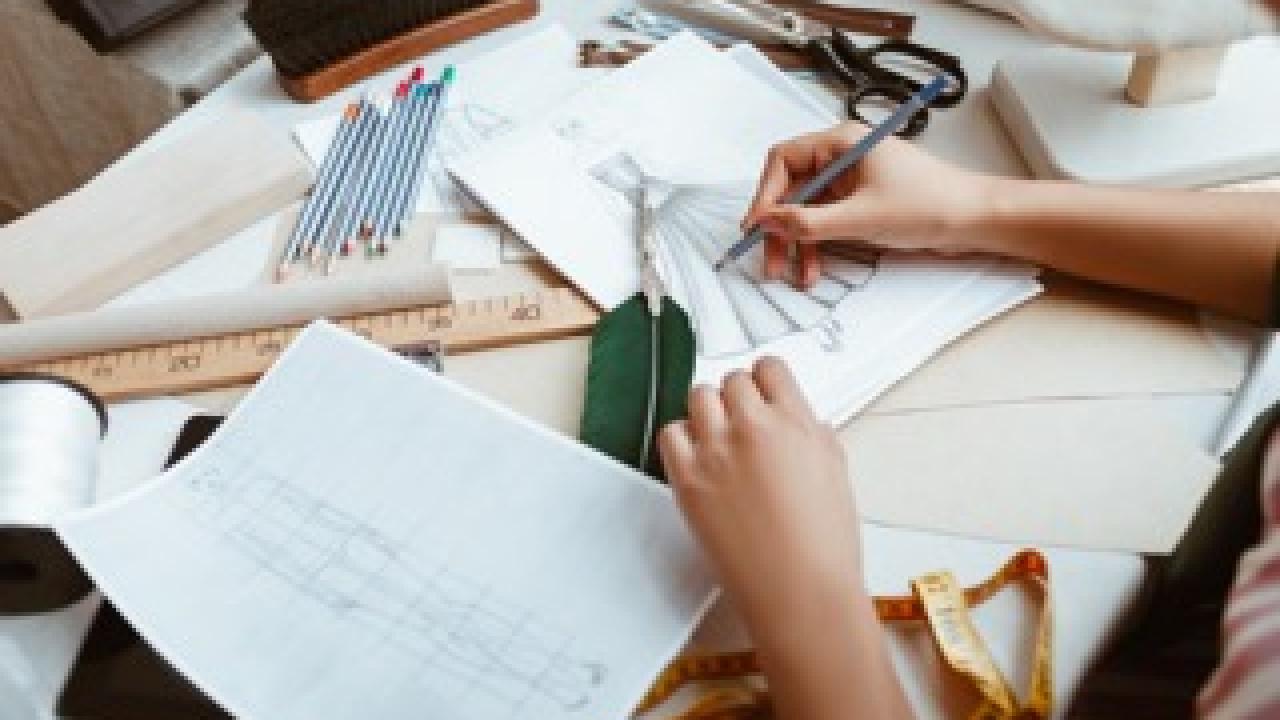 Tailor with notepad making sketches