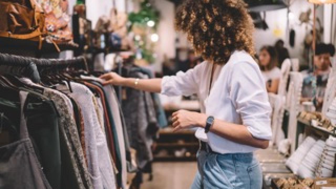 Woman looking at clothes on a rack in a shop