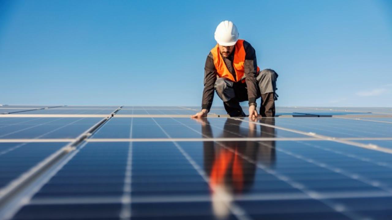 Worker installing solar panels