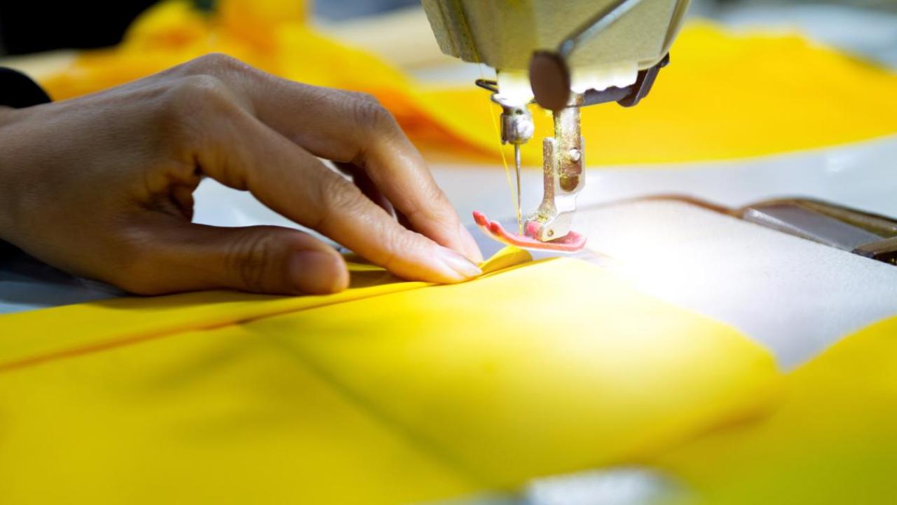 hands working on a sewing machine