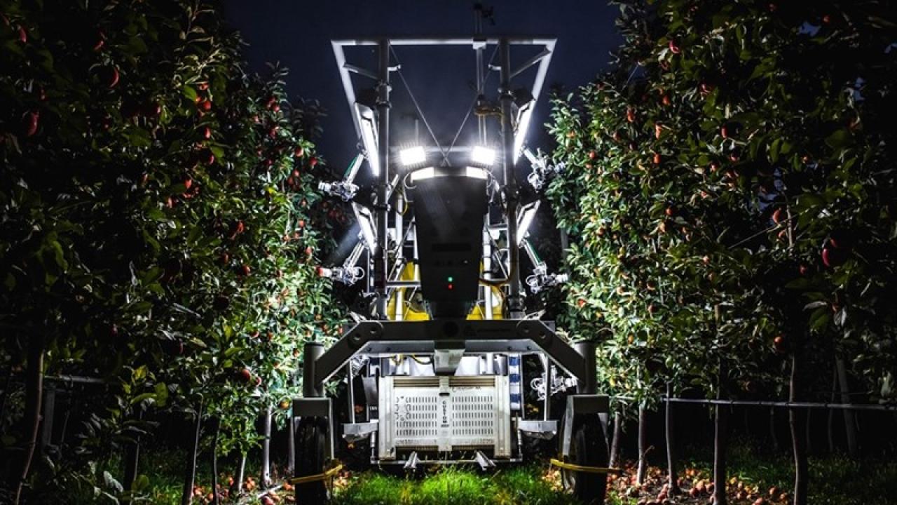 A piece of farm machinery with lights on