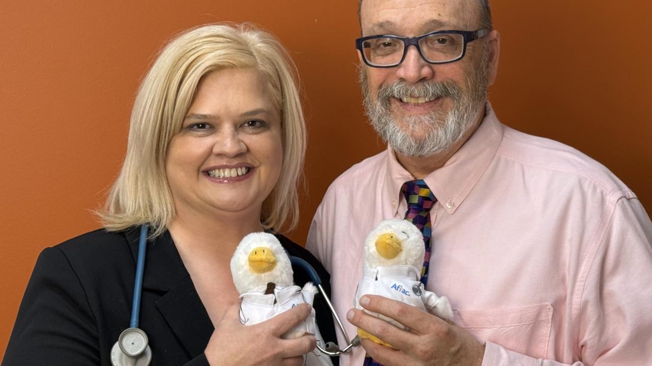Tom and Tricia shown holding Aflac Ducks.