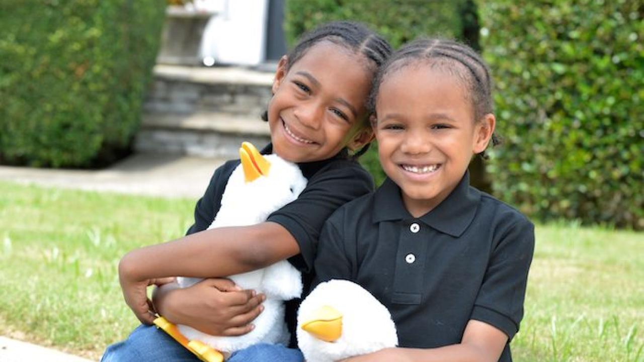 Two children holding My Special Aflac Duck, a social robot for children with cancer and sickle cell disease that was designed by the founders of Sproutel, a health tech company in Providence, R.I.SPROUTEL