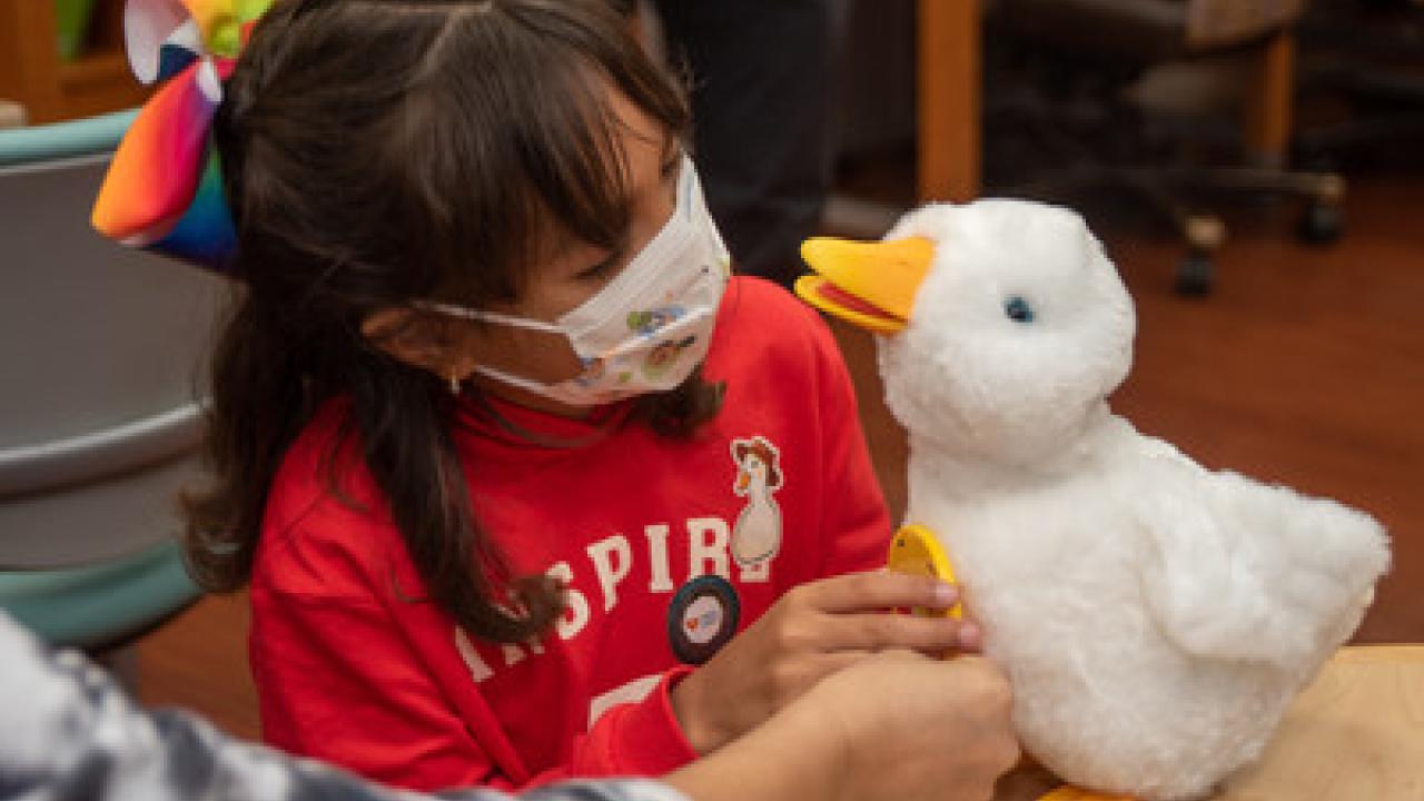Young girl holding an Aflac duck.