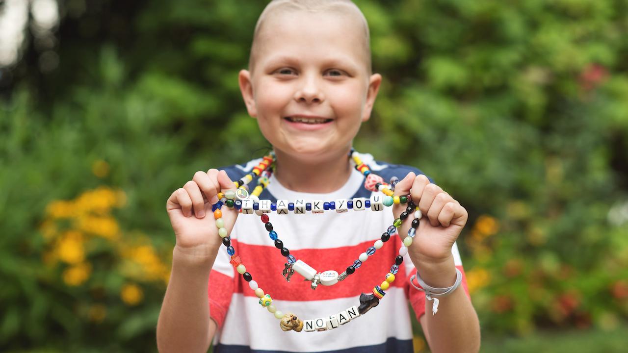 Young girl holding the beads of color.