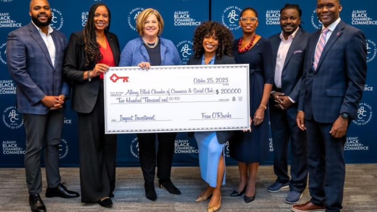 Members of Albany Black Chamber of Commerce and KeyBank representatives holding a $200,000 grant check.