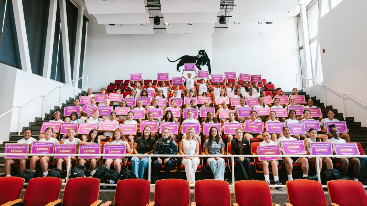 Group photo of camp participants holding boxes from Lenovo