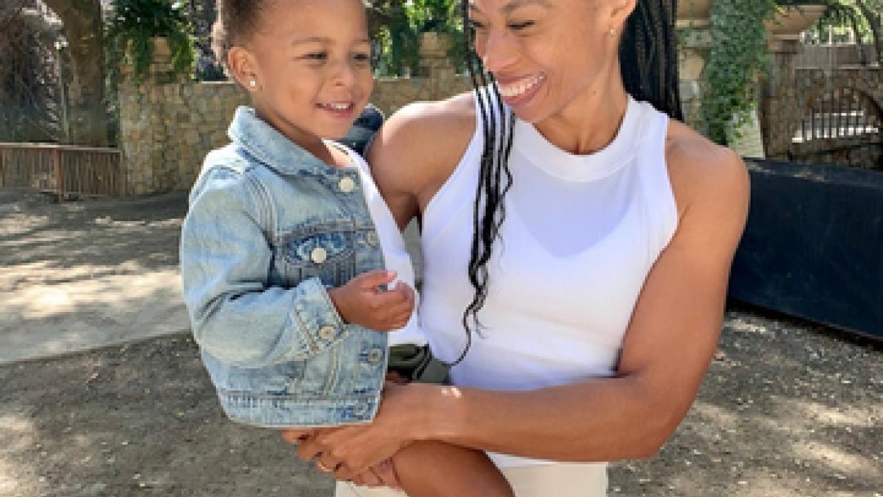 Allyson Felix holding her child