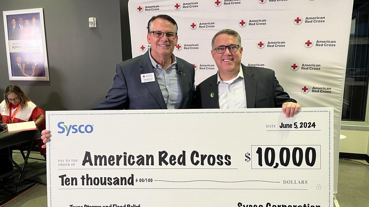 Two people holding a large cheque 