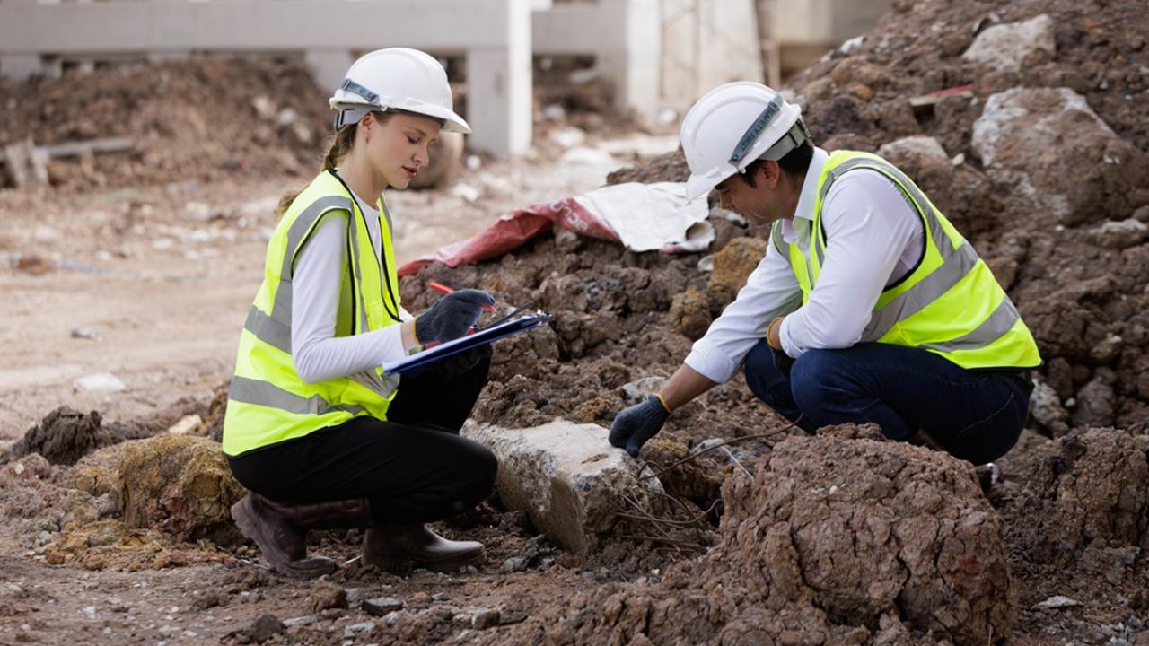 Site investigators take notes on foundation sediment 