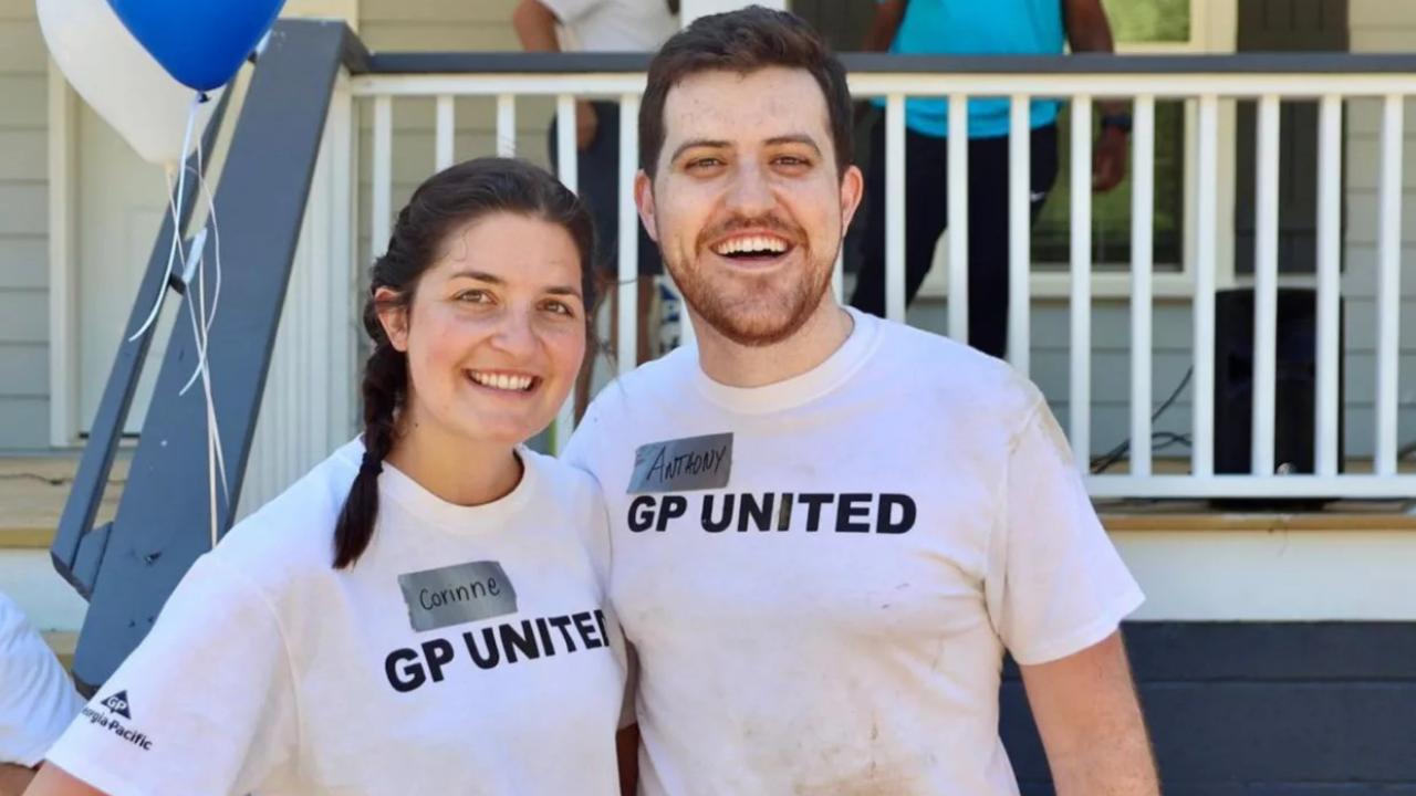 Anthony Reyna and his wife, Corinne, in front of a house
