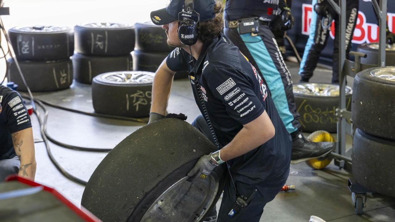 person lifting a tire