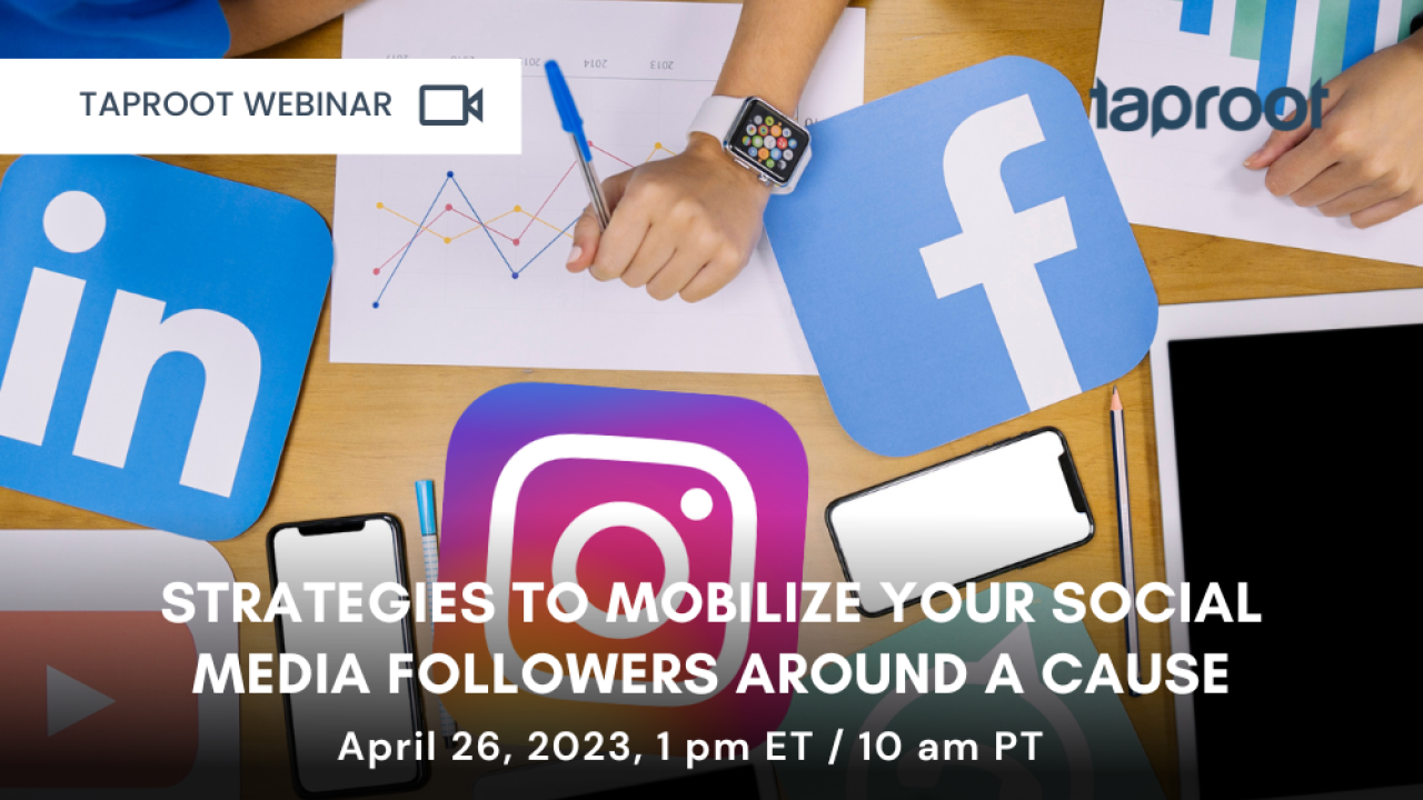 Hands working on desk with different social media icons.