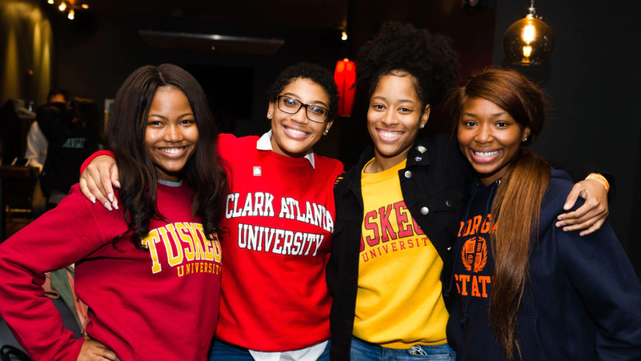 Women wearing college sweatshirts