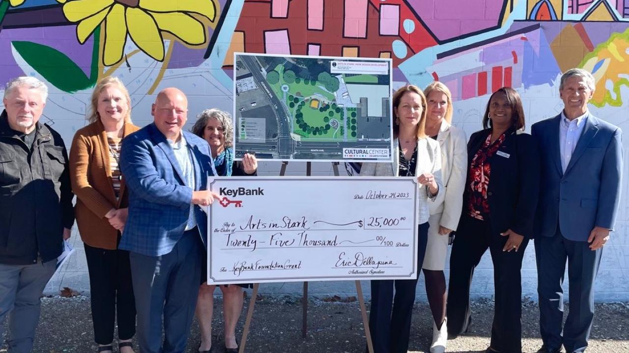 Representatives from ArtsInStark and KeyBank shown with a $25,000 grant check.