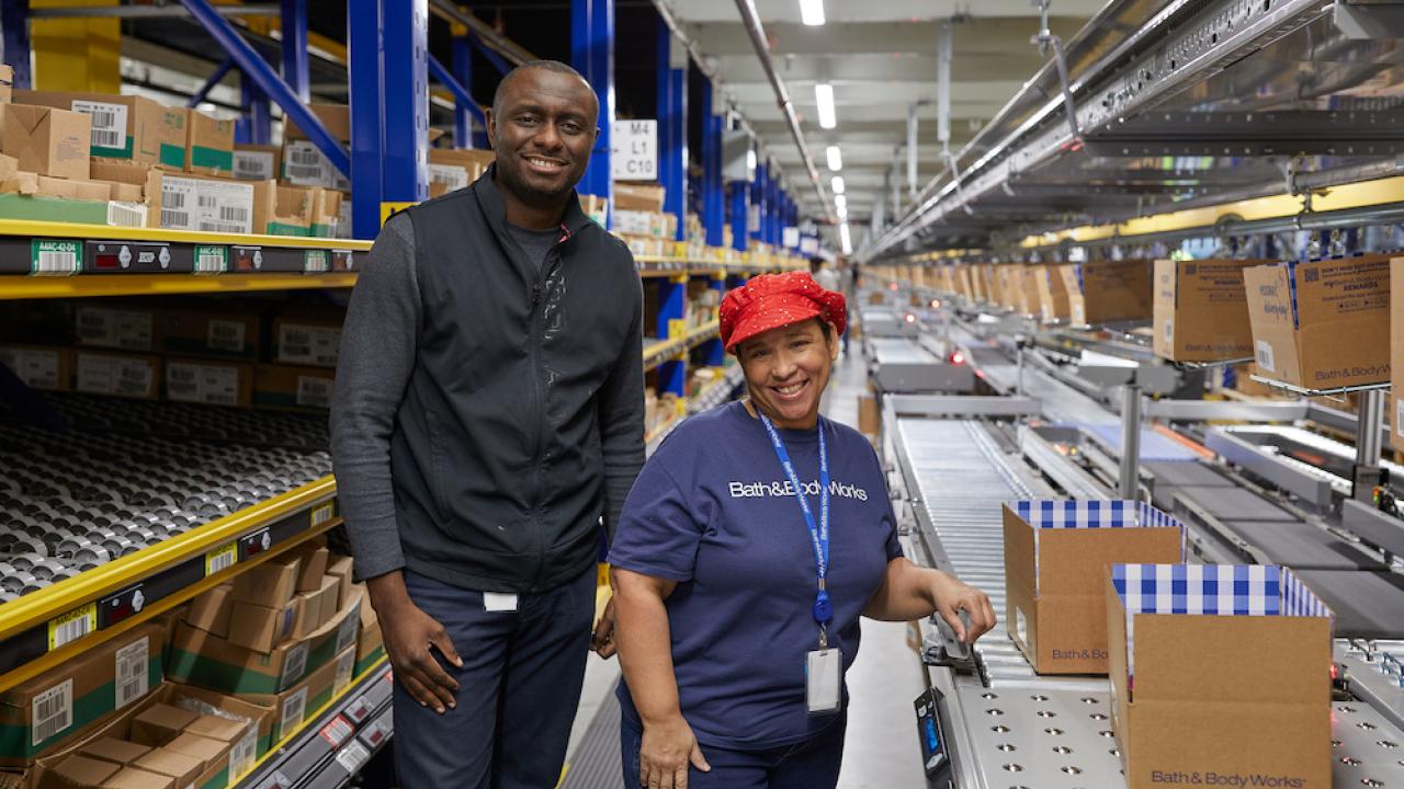 Two associates packing boxes