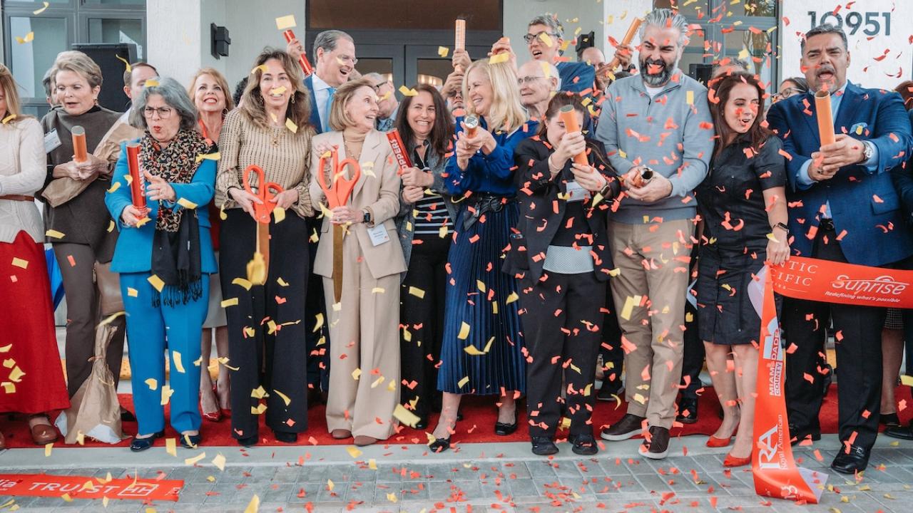 group photo behind ribbon